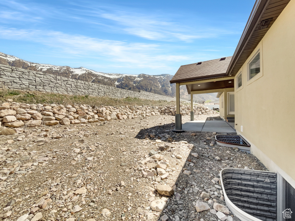 View of yard with a mountain view and a patio area