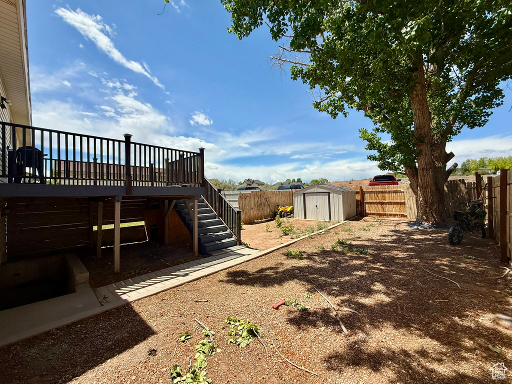 Fenced backyard featuring stairway and a deck