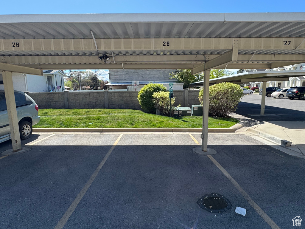 Covered parking lot featuring fence