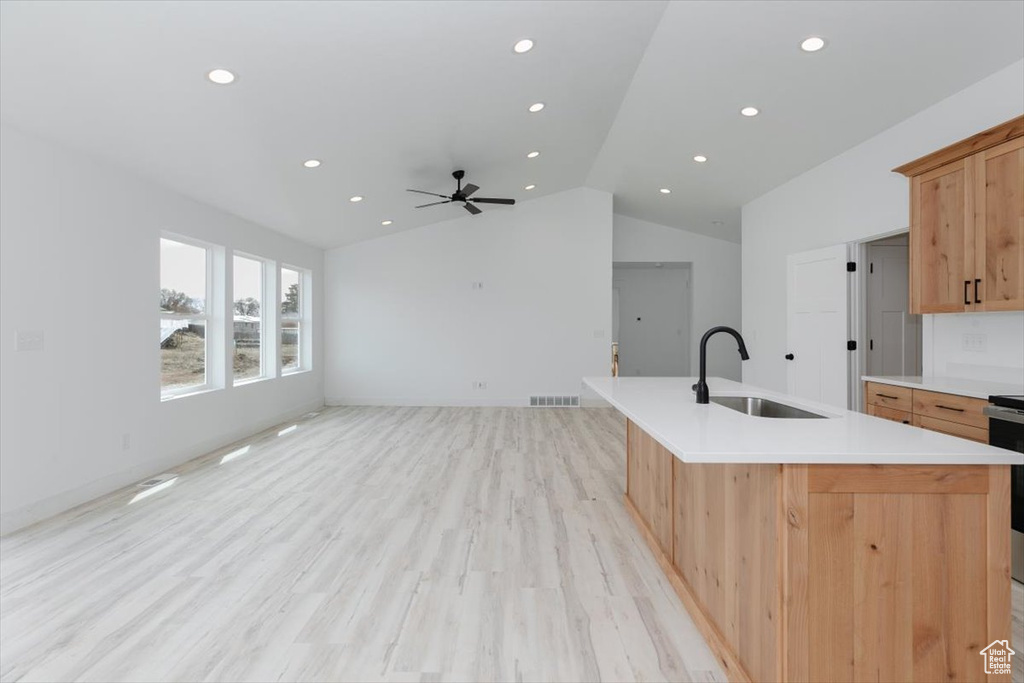 Kitchen featuring a sink, visible vents, recessed lighting, and lofted ceiling