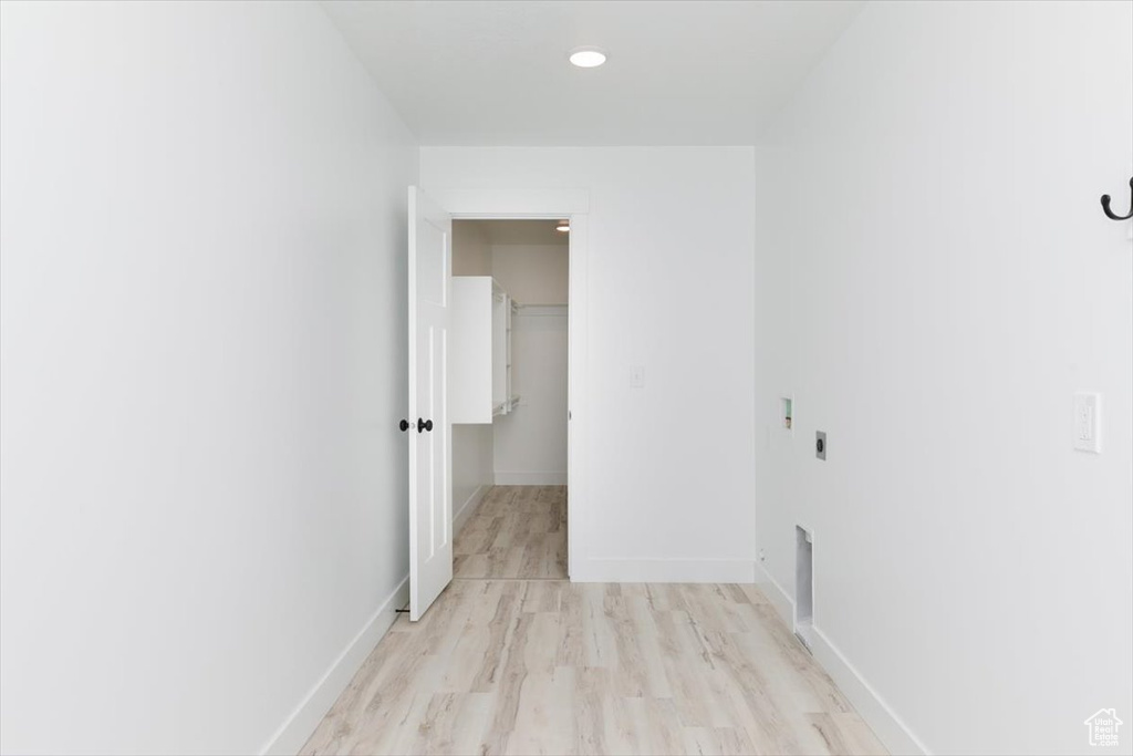 Hall with baseboards and light wood-style floors