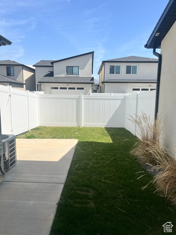 View of yard featuring cooling unit and a fenced backyard