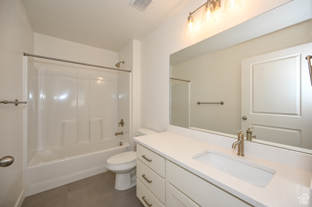 Full bathroom with vanity, bathing tub / shower combination, tile patterned flooring, toilet, and visible vents