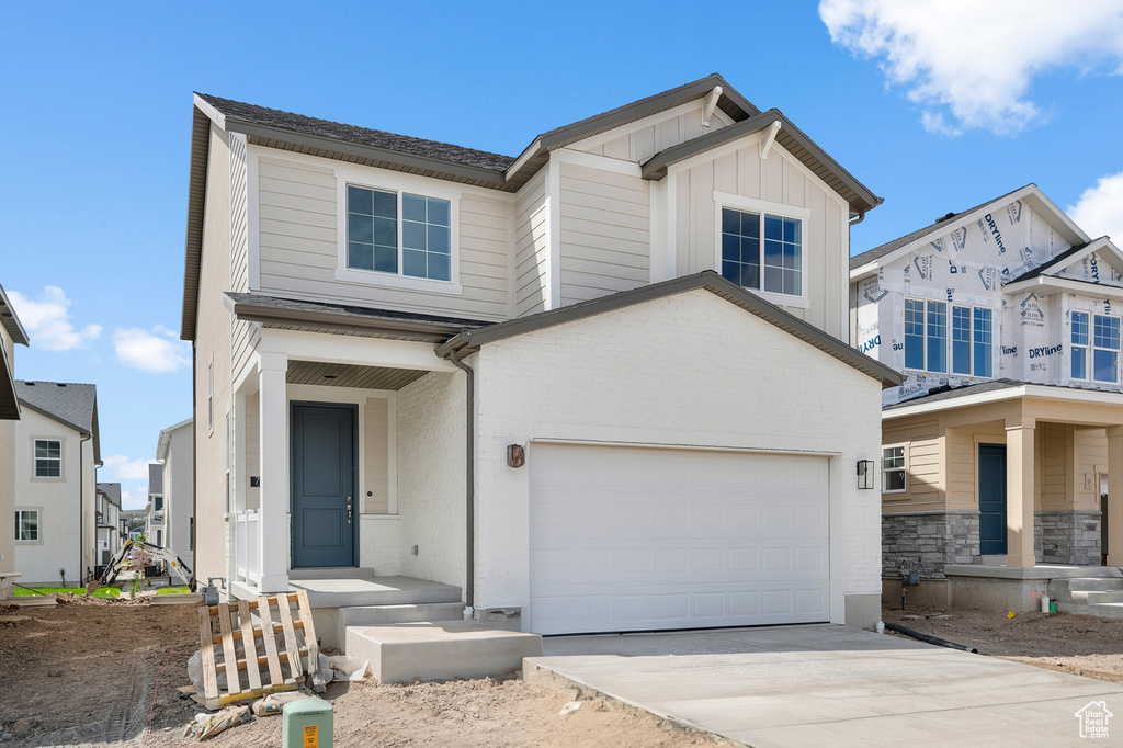 View of front of home featuring driveway and board and batten siding