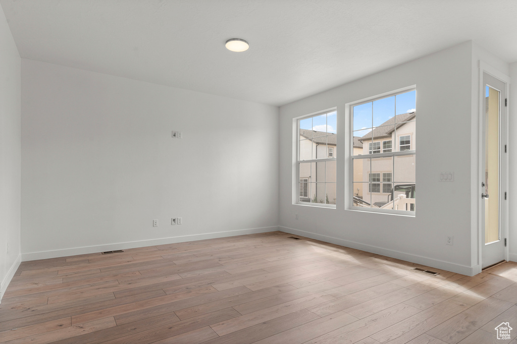 Spare room with light wood-style flooring and baseboards