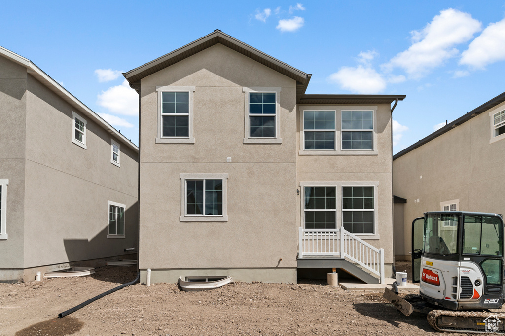 Rear view of property featuring stucco siding
