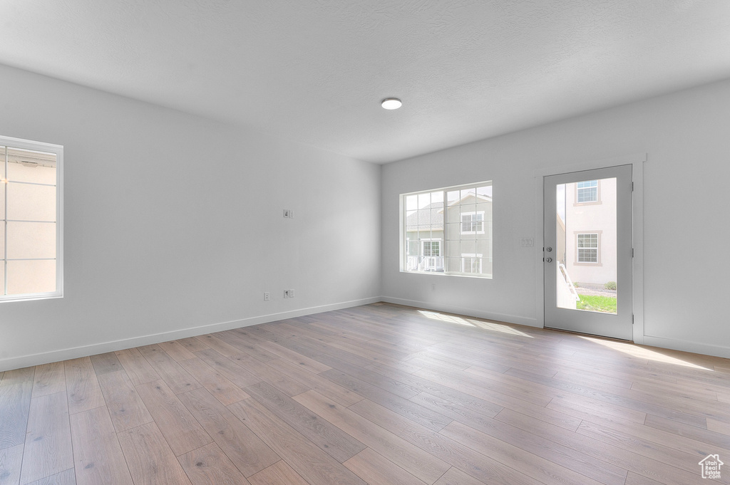 Empty room featuring light wood finished floors and baseboards
