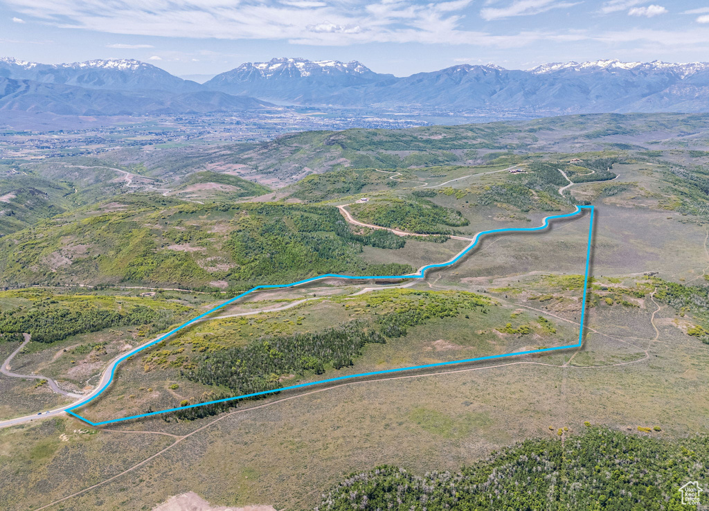 Aerial view of property\\\'s location featuring property parcel outlined and a mountainous background