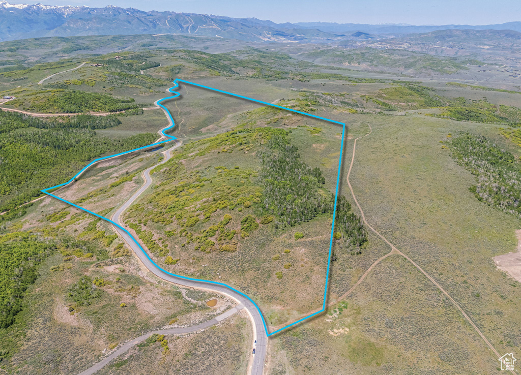Aerial view of sparsely populated area with property boundaries highlighted and mountains