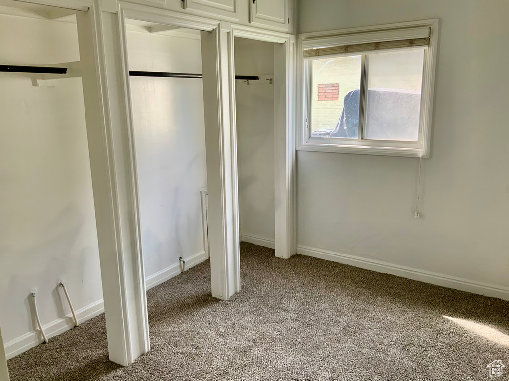 Unfurnished bedroom featuring carpet flooring and baseboards