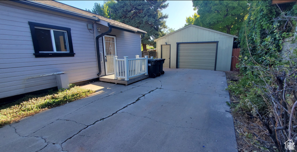 Exterior space featuring an outdoor structure, a garage, and driveway