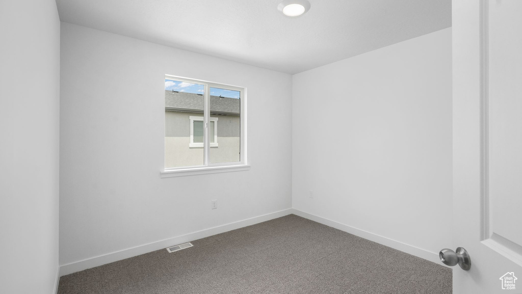 Unfurnished room with carpet and baseboards