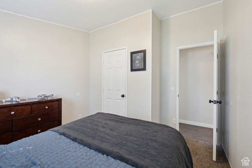 Bedroom featuring ornamental molding, baseboards, and carpet