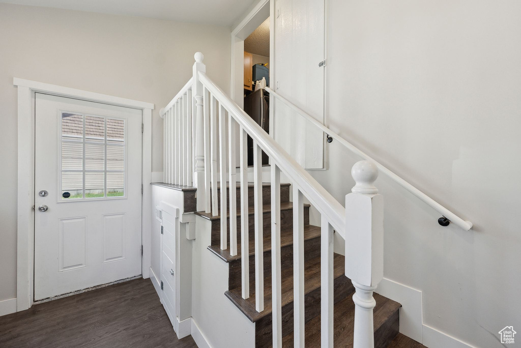 Staircase featuring baseboards and wood finished floors
