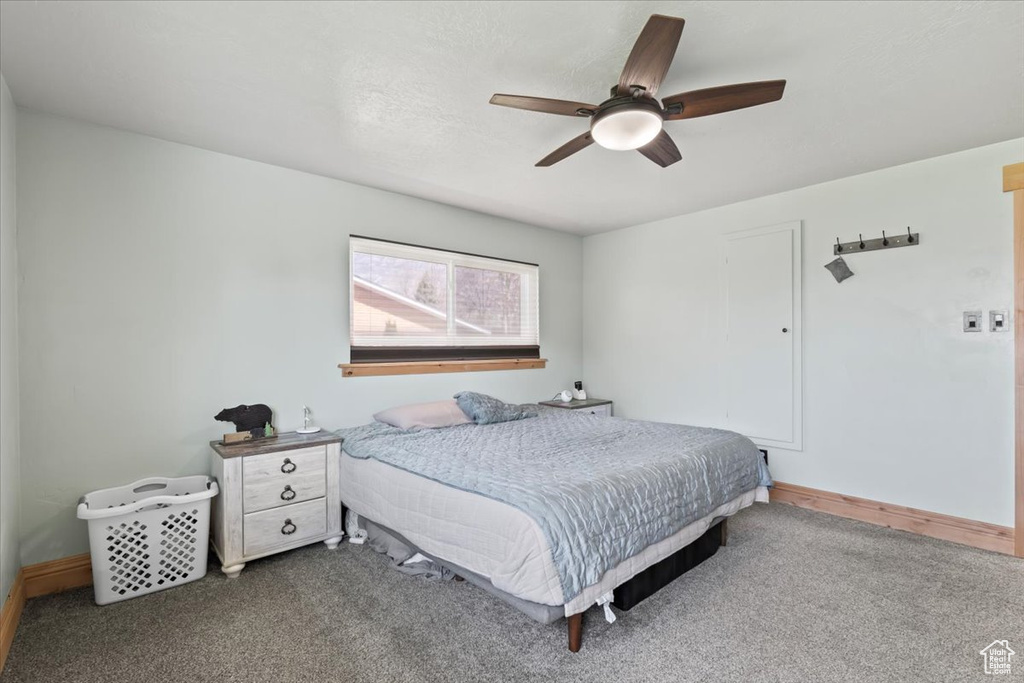 Bedroom with carpet floors, ceiling fan, and baseboards