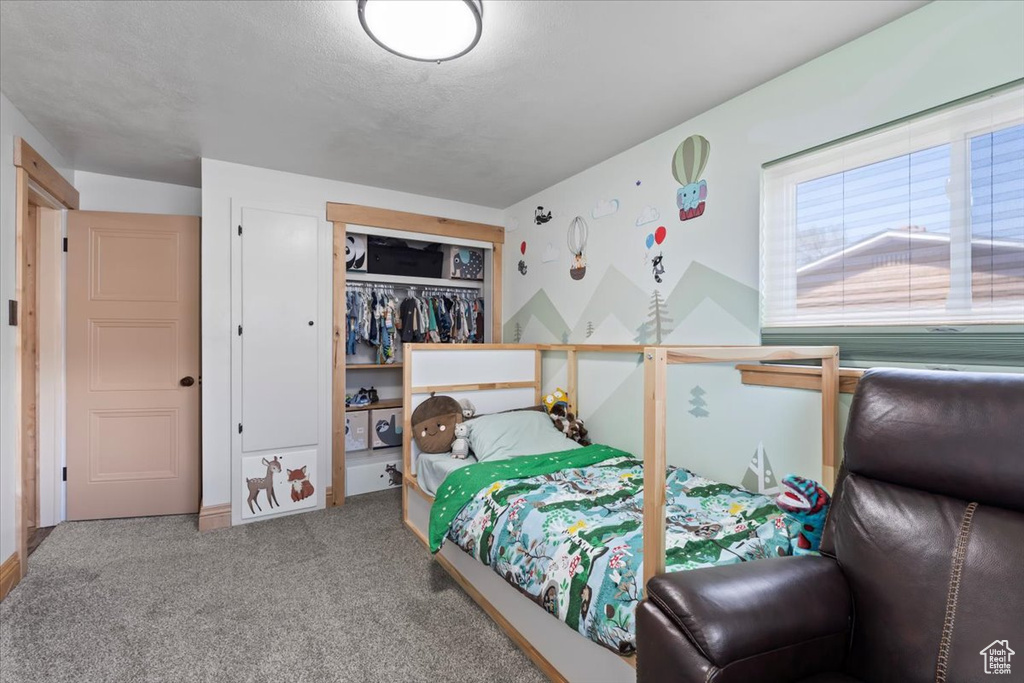 Carpeted bedroom with a closet