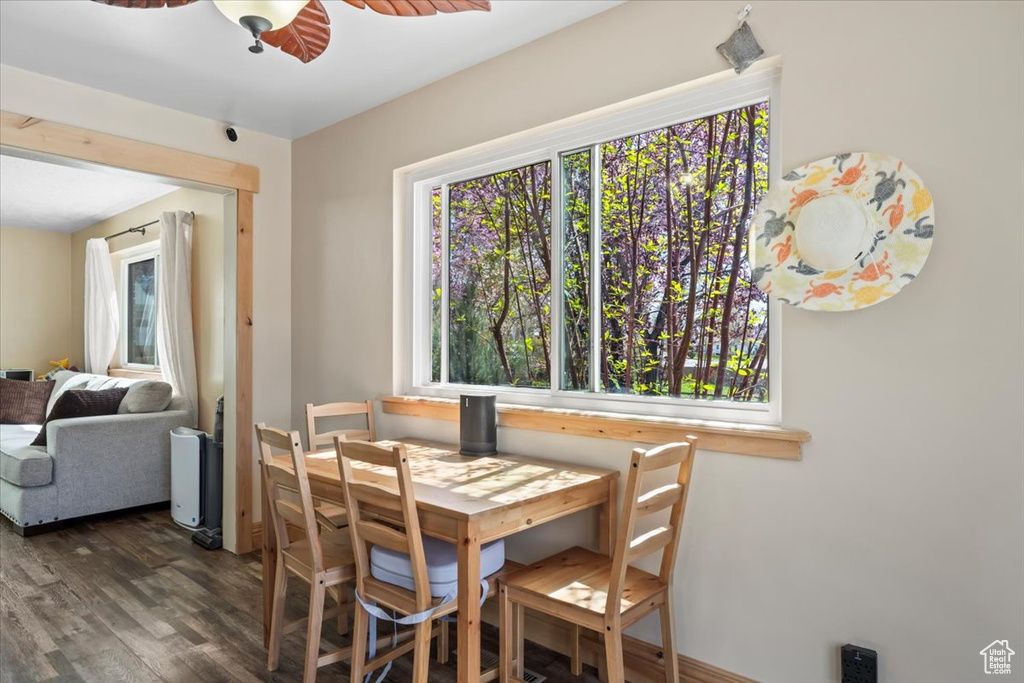 Dining space with wood finished floors and ceiling fan