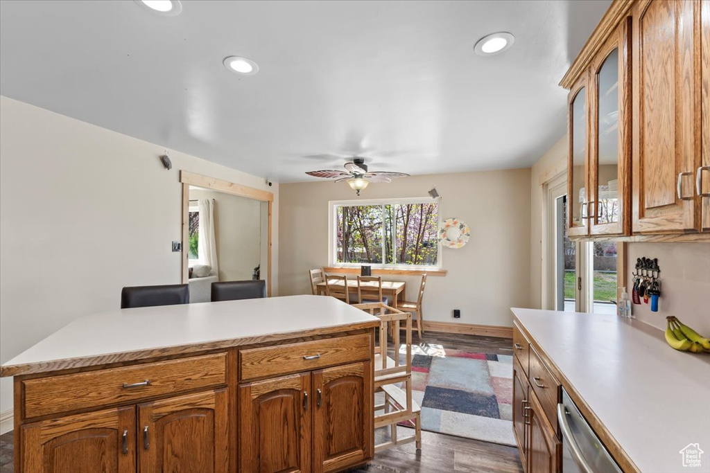 Kitchen with ceiling fan, recessed lighting, dark wood-style flooring, light countertops, and baseboards