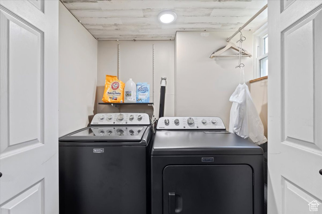 Clothes washing area featuring laundry area and washer and clothes dryer