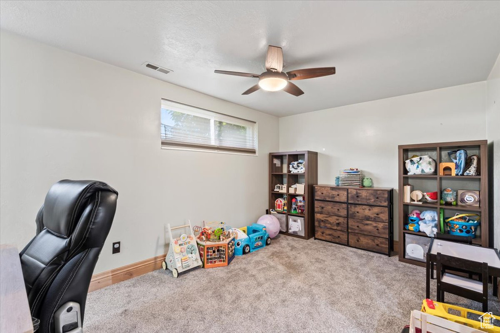 Home office featuring visible vents, a ceiling fan, and carpet floors