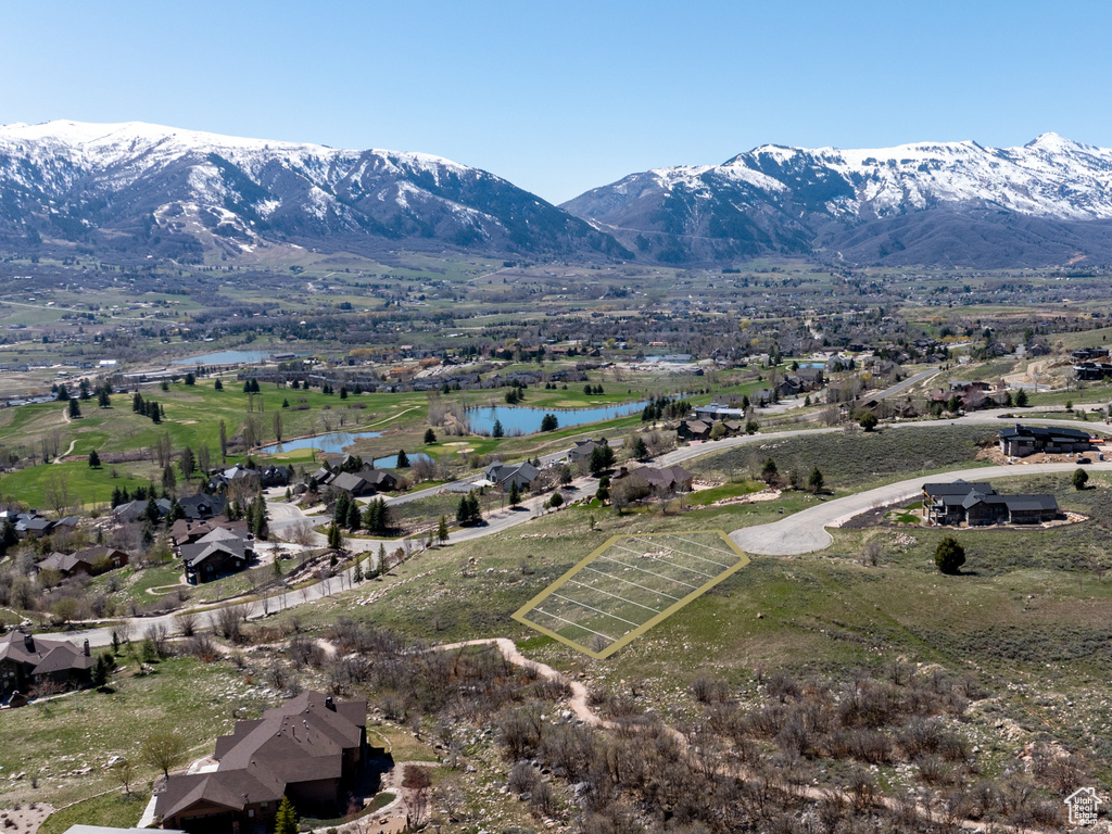 Birds eye view of property featuring a water and mountain view