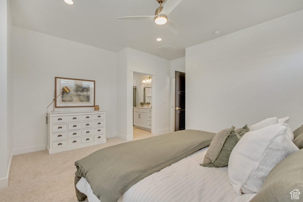 Bedroom with ensuite bathroom, light colored carpet, a ceiling fan, recessed lighting, and baseboards
