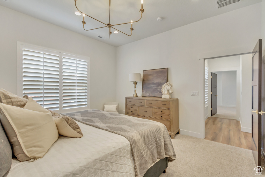 Bedroom with visible vents, baseboards, an inviting chandelier, recessed lighting, and light colored carpet