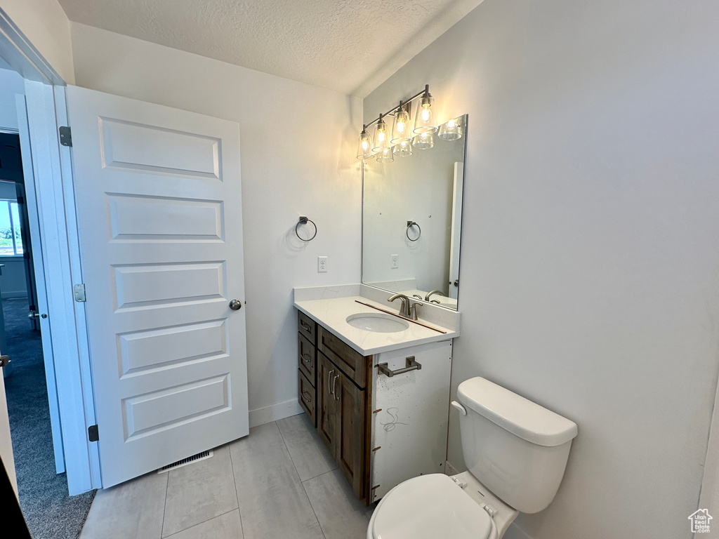 Bathroom featuring vanity and a textured ceiling