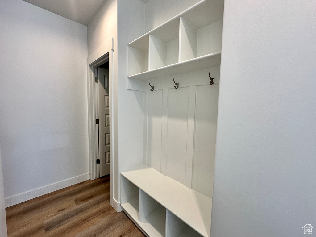 Mudroom with wood finished floors and baseboards