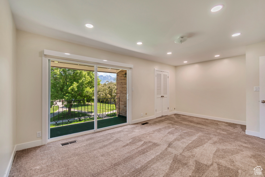 Empty room with carpet, baseboards, and recessed lighting