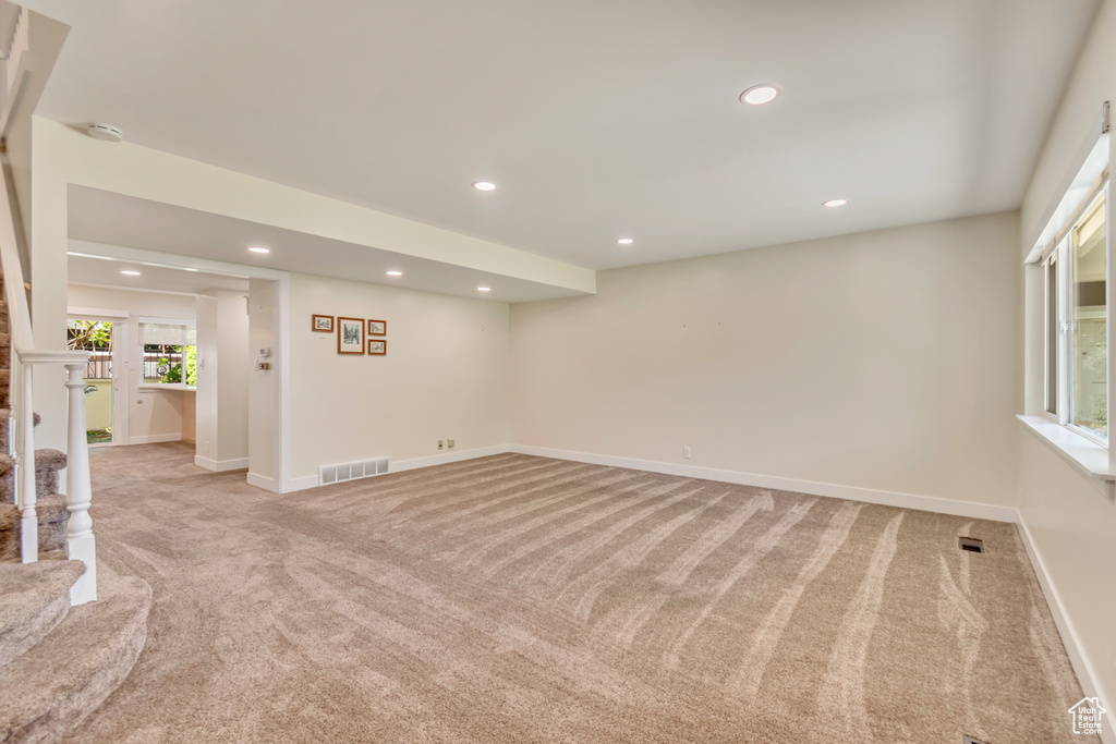 Unfurnished room with light colored carpet, recessed lighting, baseboards, and a smoke detector