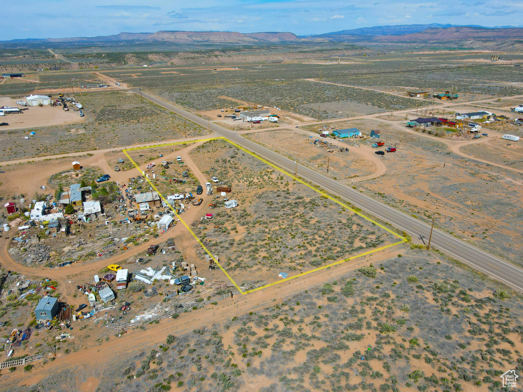 Aerial overview of property's location with a mountain backdrop, rural landscape, and a desert landscape