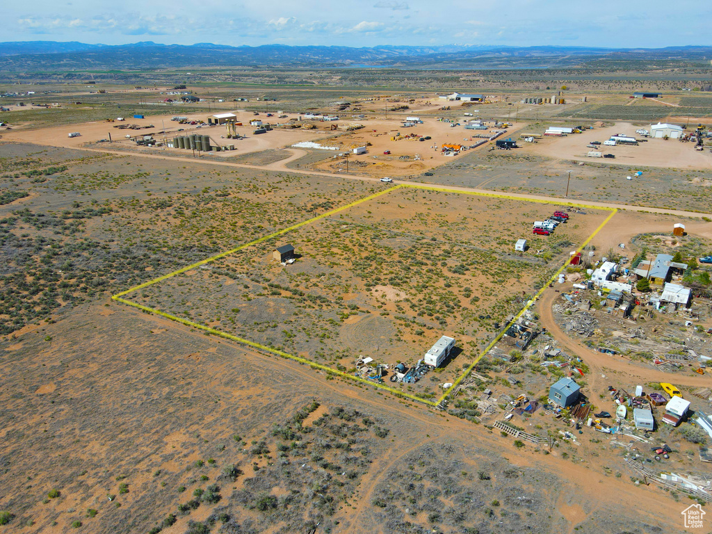 Aerial overview of property's location featuring property boundaries highlighted, rural landscape, and mountains
