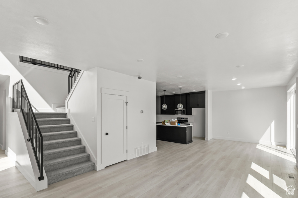 Interior space featuring visible vents, recessed lighting, wood finished floors, and baseboards