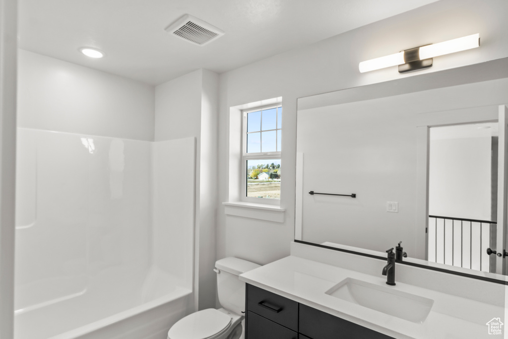 Full bath with toilet, visible vents, vanity, and  shower combination