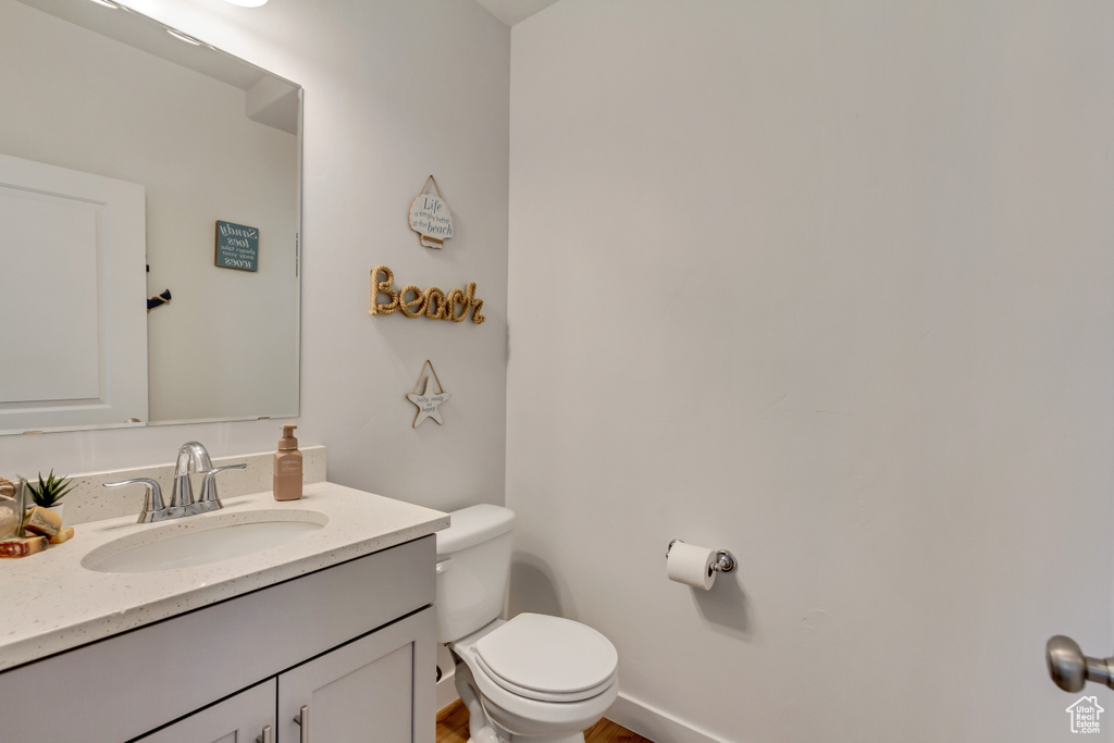Half bathroom featuring toilet and vanity