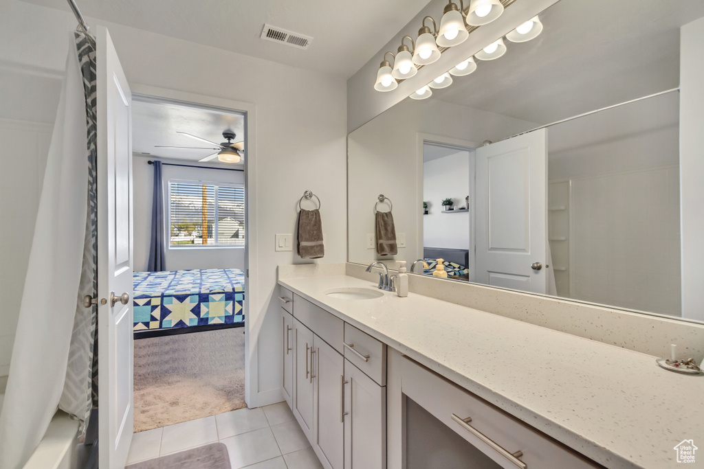 Ensuite bathroom with vanity, tile patterned floors, ensuite bath, a ceiling fan, and visible vents