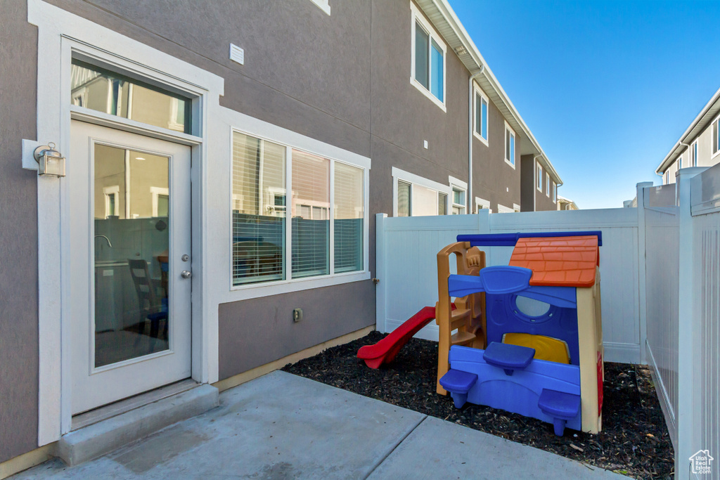 View of patio / terrace featuring a fenced backyard and a playground