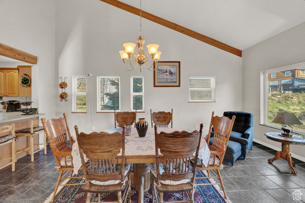 Dining room with beamed ceiling, an inviting chandelier, and high vaulted ceiling