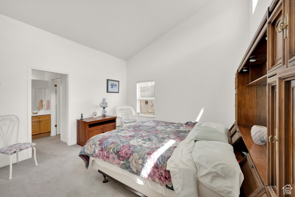 Bedroom featuring high vaulted ceiling, baseboards, and light carpet