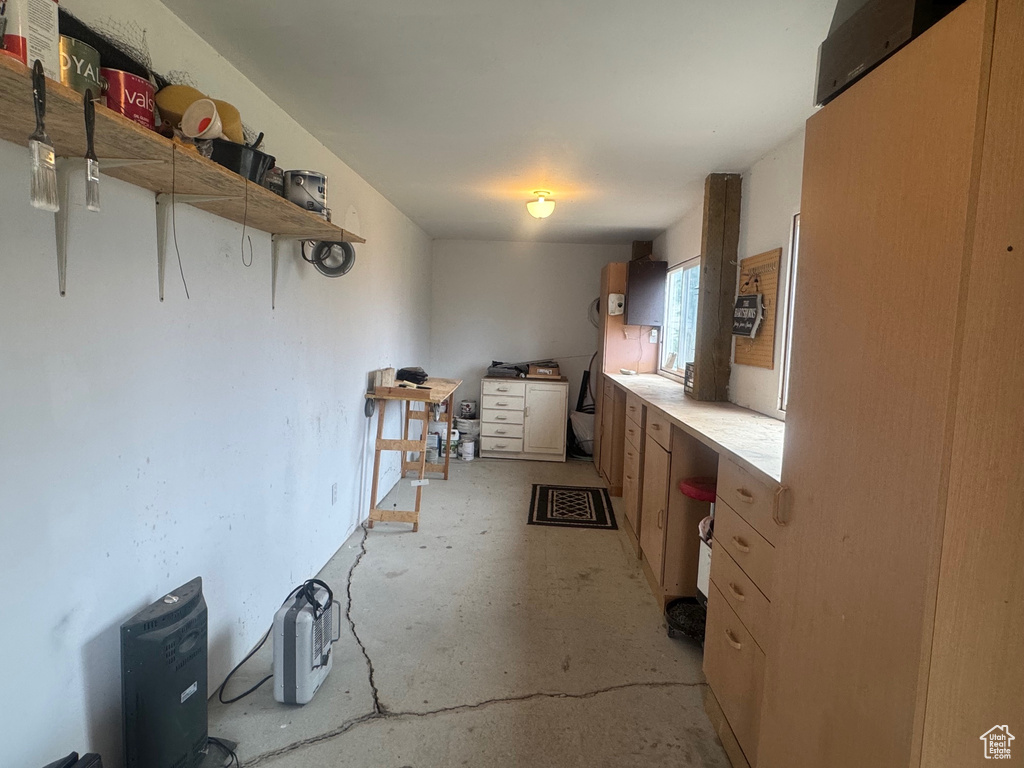 Kitchen featuring unfinished concrete floors and open shelves
