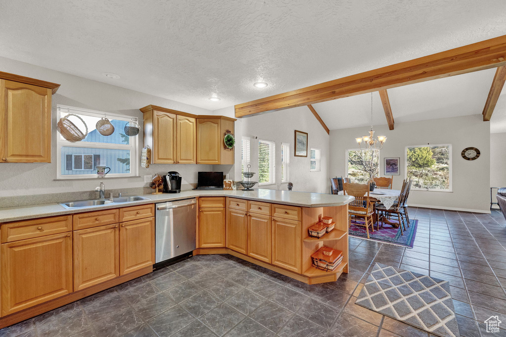 Kitchen with stainless steel dishwasher, light countertops, a sink, lofted ceiling with beams, and a peninsula