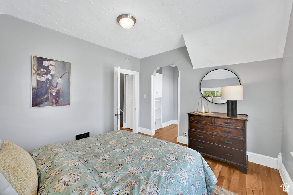 Bedroom with baseboards and wood finished floors