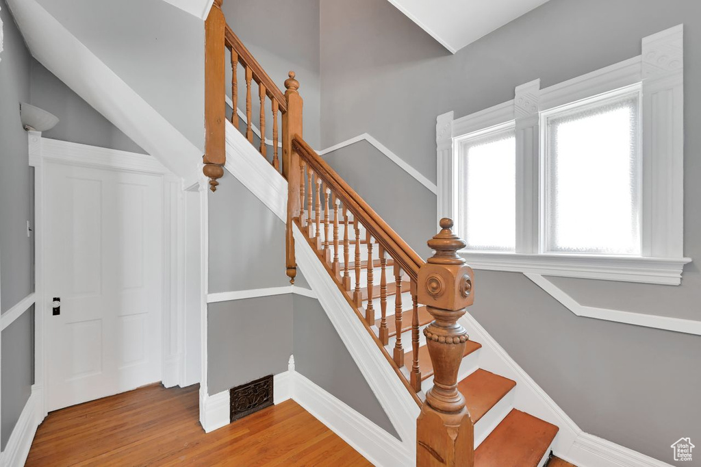 Stairway with baseboards and wood finished floors