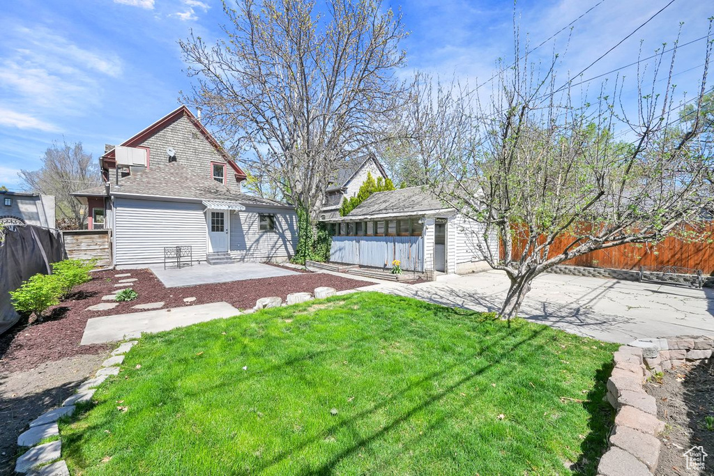 View of yard with a patio, entry steps, and a fenced backyard