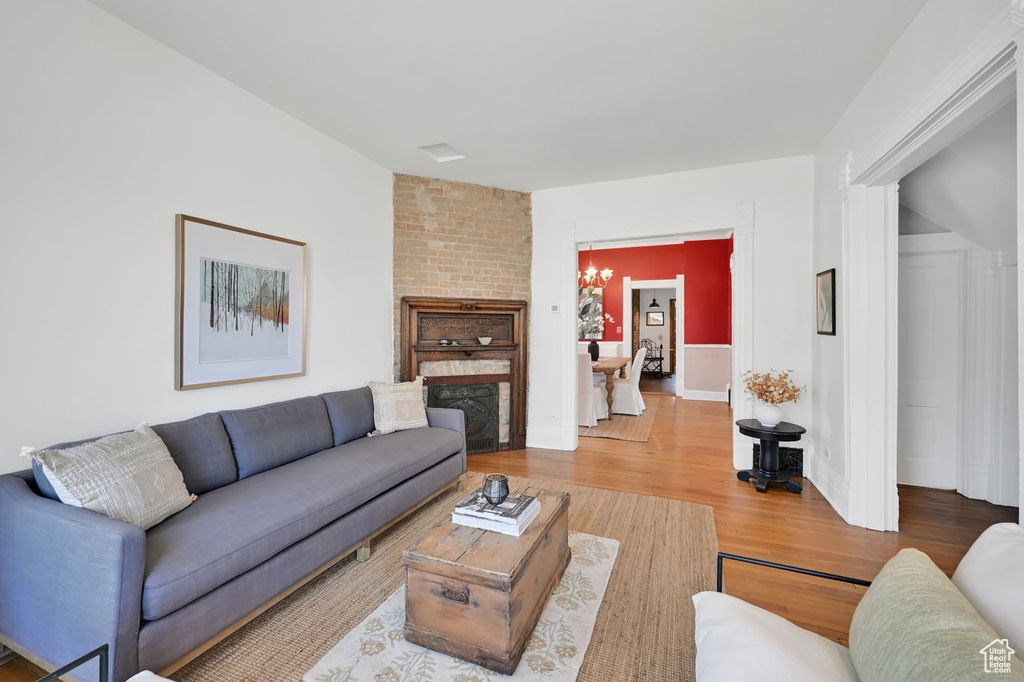 Living room featuring a chandelier and wood finished floors