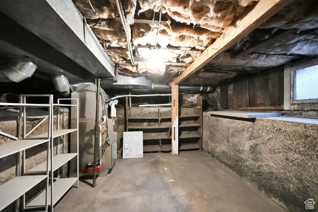 Unfinished basement featuring heating unit