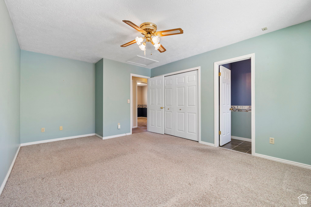 Unfurnished bedroom with a closet, baseboards, and carpet