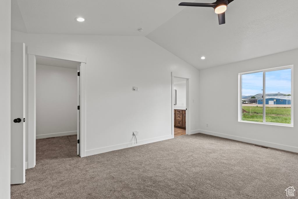 Unfurnished bedroom featuring carpet flooring, lofted ceiling, baseboards, recessed lighting, and ceiling fan