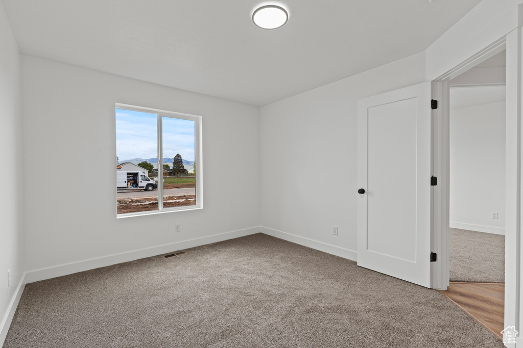 Unfurnished bedroom featuring carpet floors and baseboards
